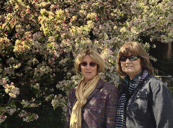 Smartphone Photo of two women in front of blooming bush